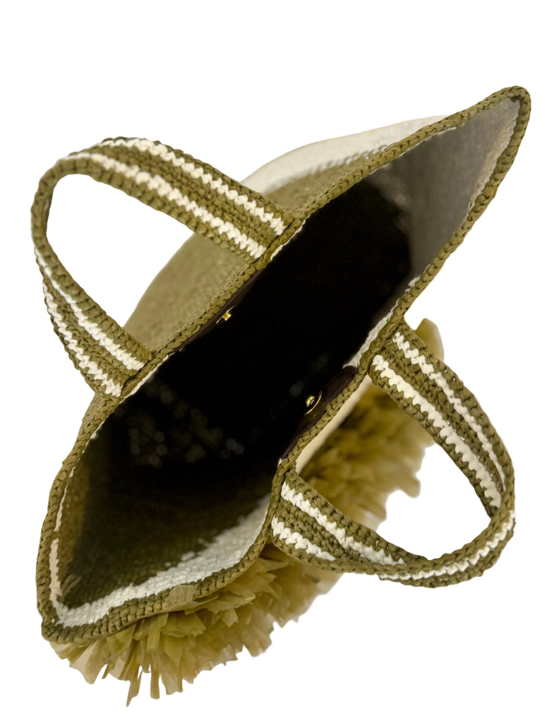 Close-up of a decorative brush with a handle on a light background