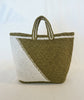 Woven bag with green and white pattern on a light background